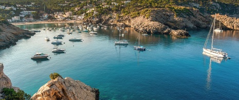 Sailboats anchoring in Cala Vadella in Ibiza, Balearic Islands Sailboats anchoring in Cala Vadella in Ibiza, Balearic Islands