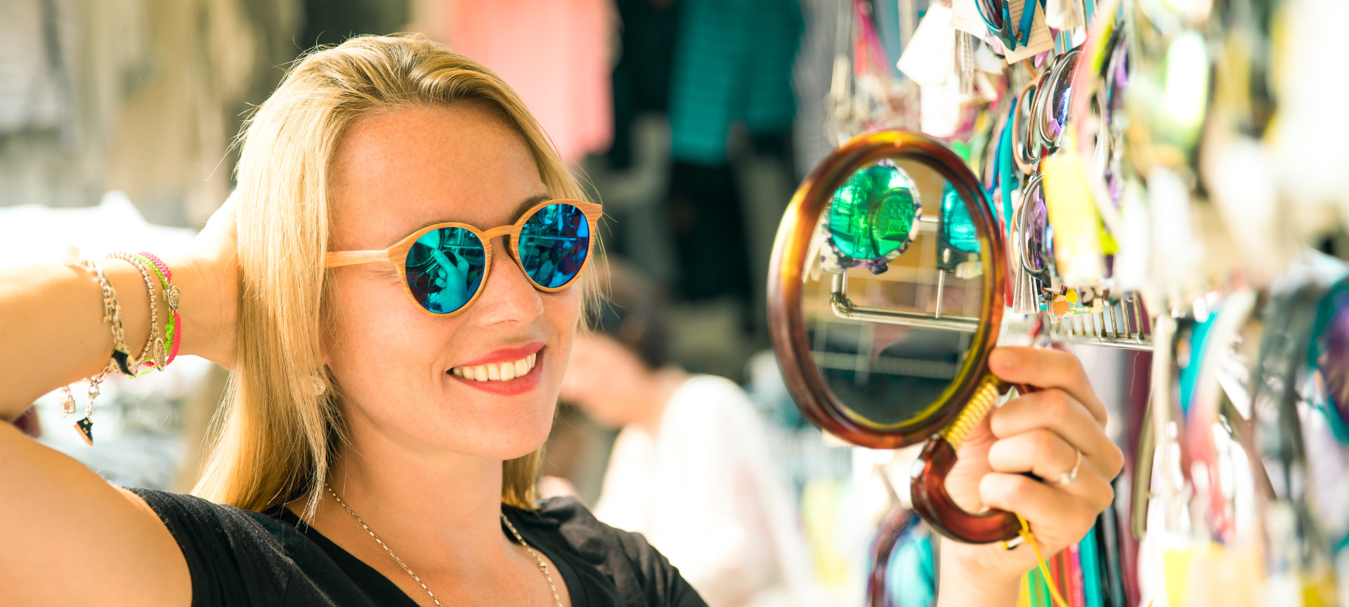 Tourist trying on glasses at a street market