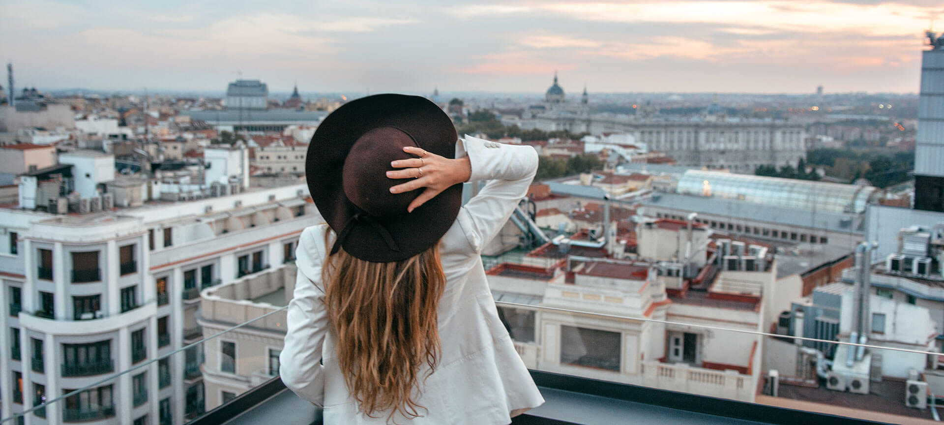 City tourism experiences Woman looking at the rooftops in Madrid