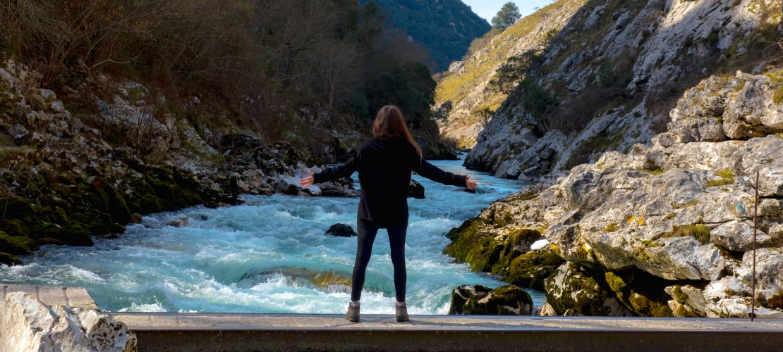 Girl enjoying the views of the river Cares in Asturias Girl enjoying the views of the river Cares in Asturias