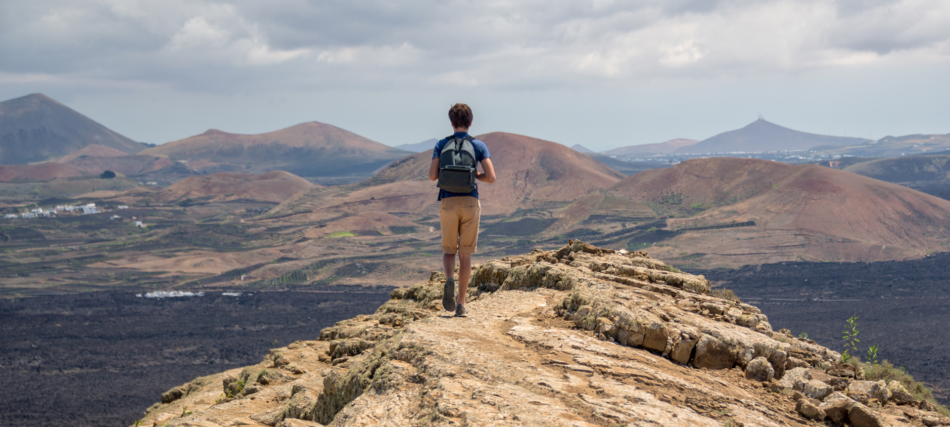Tourist walking on route to Caldera Blanca in Lanzarote, Canary Islands