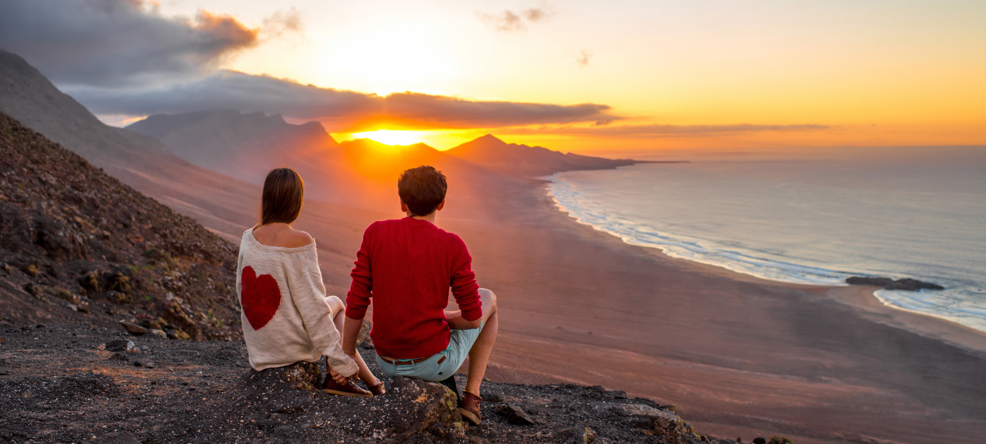 Couple in love looking at the landscape in Fuerteventura (Canary Islands).
