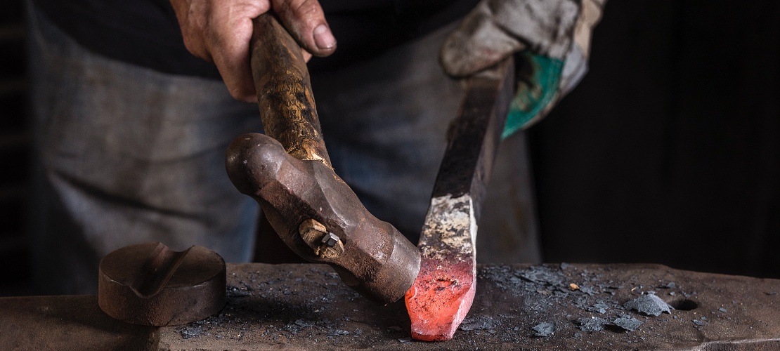 Craftsman working on a sword in a workshop in Toledo.
