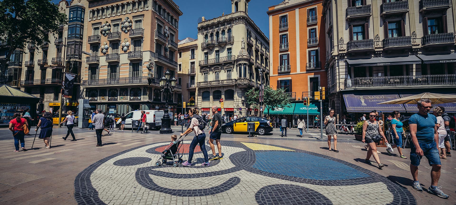 People passing by the Miró mosaic on Las Ramblas. Barcelona