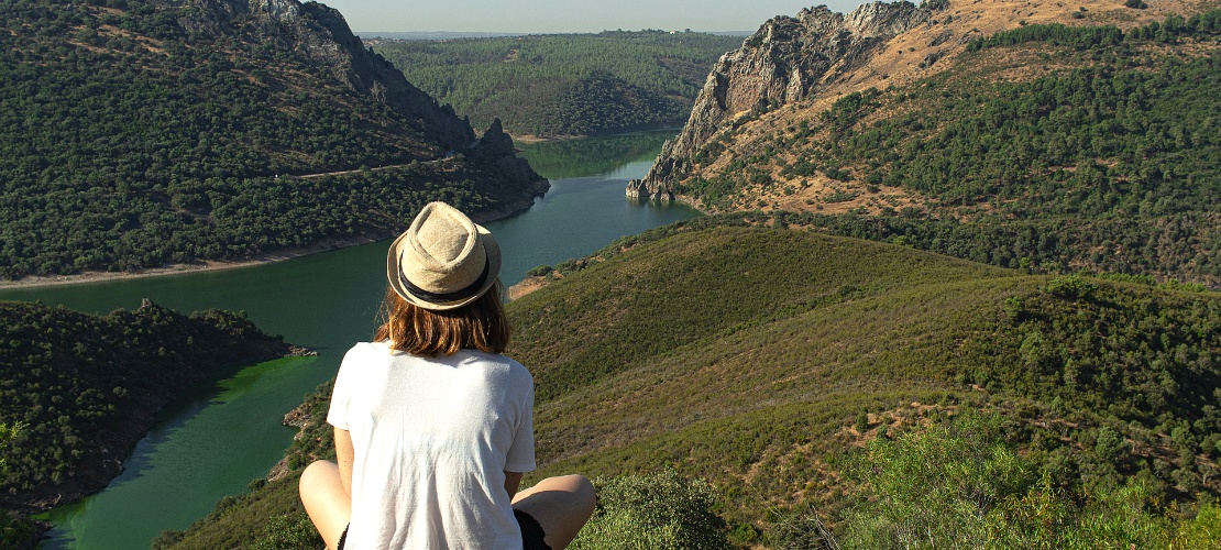 Young man looking out over the River Tagus on its course through the Monfragüe National Park. Young man looking out over the River Tagus on its course through the Monfragüe National Park.