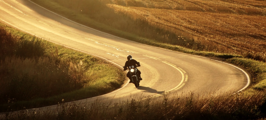 Motorcyclist riding on a road Motorcyclist riding on a road