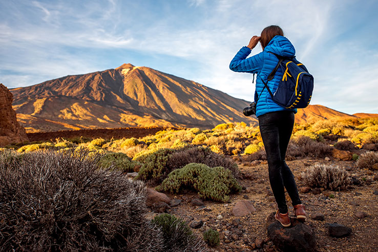 Hiker by the Mount Teide on the island of Tenerife, the Canary Islands Hiker by the Mount Teide on the island of Tenerife, the Canary Islands