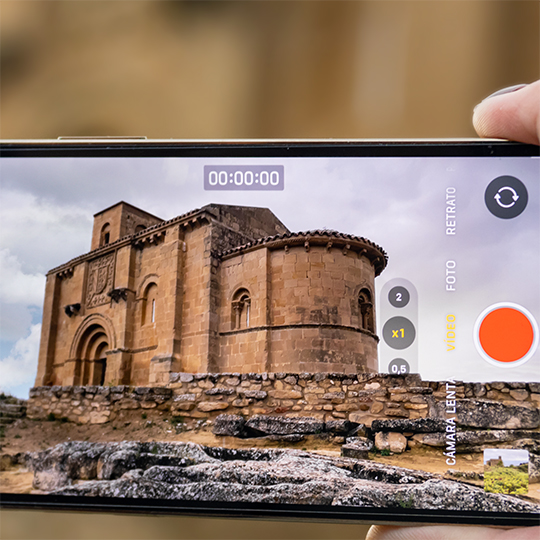 Mobile phone filming a church. Rioja Alta wine route
