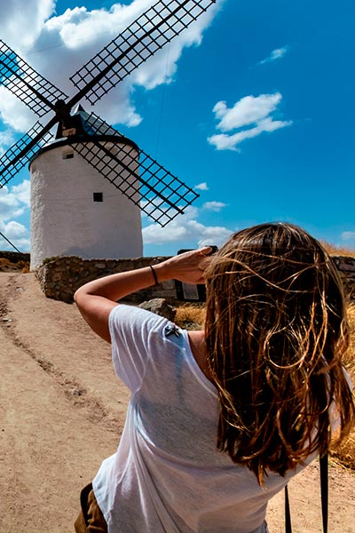 Girl taking a picture at the windmills of Consuegra, Toledo