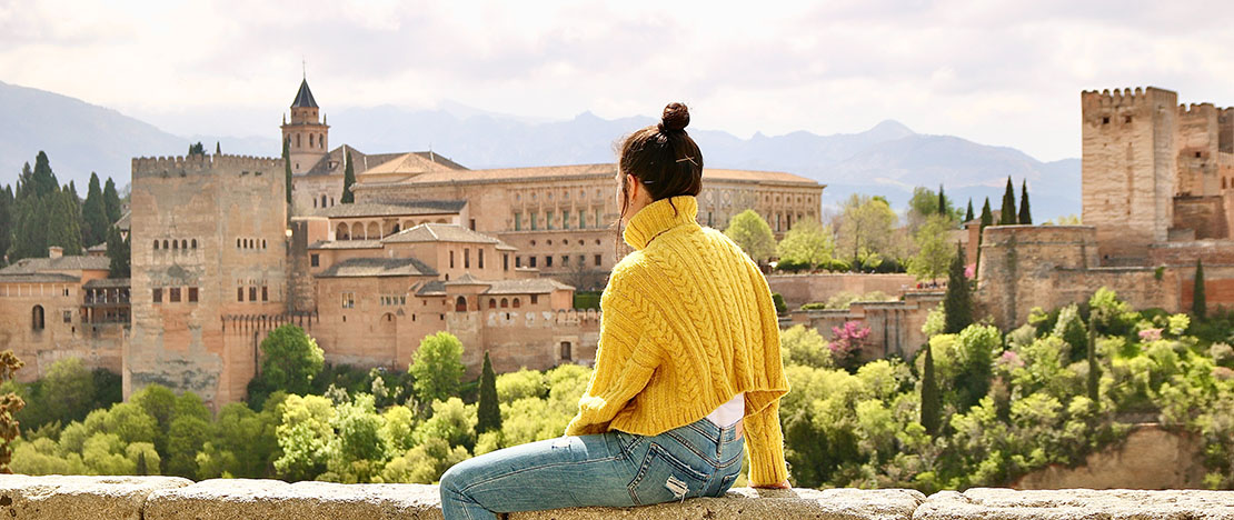 Tourist admiring the views of the Alhambra in Granada, Andalusia Tourist admiring the views of the Alhambra in Granada, Andalusia