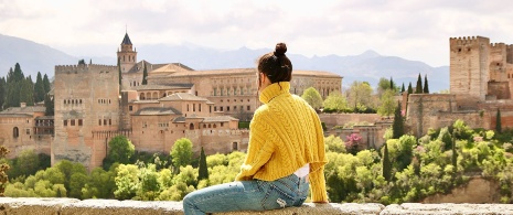 Tourist admiring the views of the Alhambra in Granada, Andalusia Tourist admiring the views of the Alhambra in Granada, Andalusia