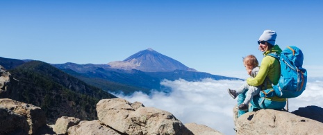 Tourist and baby looking at the Teide in Tenerife, Canary Islands Tourist and baby looking at the Teide in Tenerife, Canary Islands