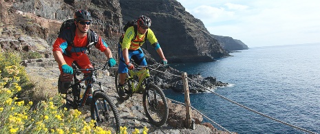 Cyclists on the coast of La Palma, Canary Islands Cyclists on the coast of La Palma, Canary Islands