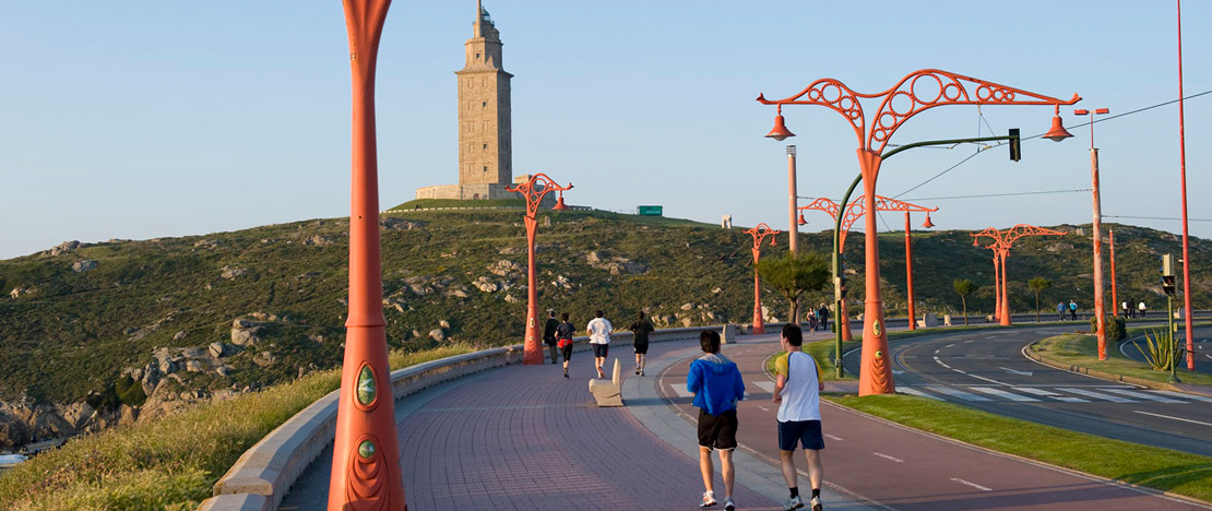 People running and walking along the seaside promenade in A Coruña People running and walking along the seaside promenade in A Coruña