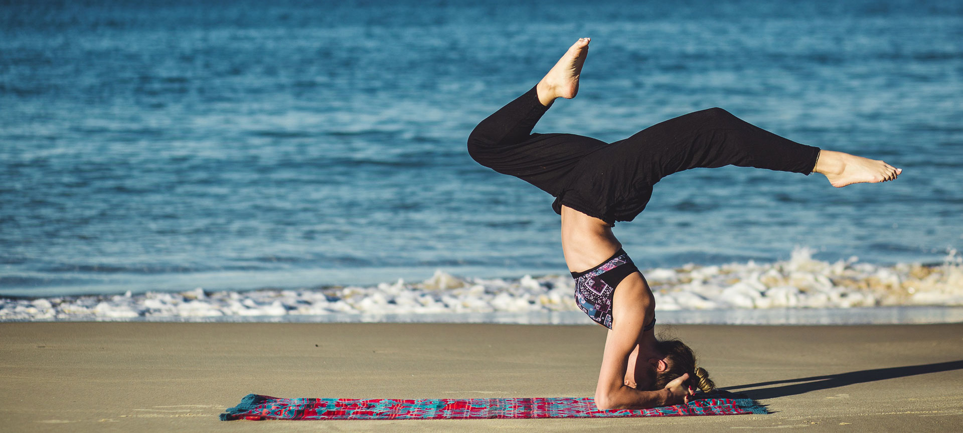 Girl practising yoga on the beach Girl practising yoga on the beach